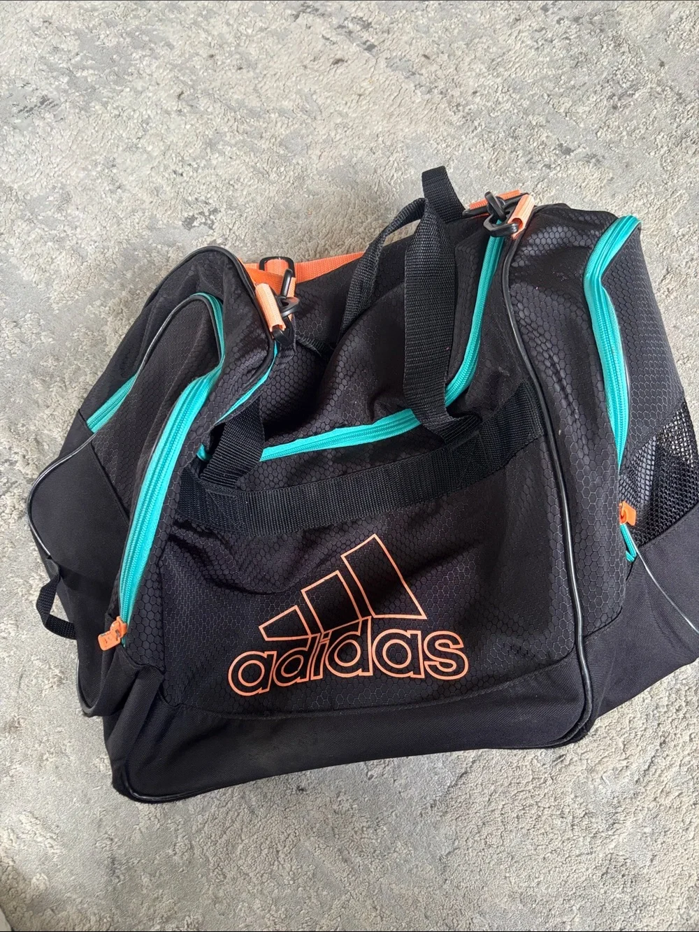 adidas Black Duffel Bag with Teal Zippers and Orange Logo